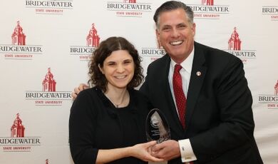 Caroline Stanley receives an award from President Clark.