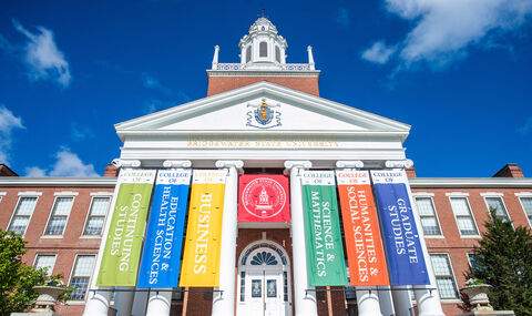 The front of Boyden Hall with the academic college banners displayed for Commencement season