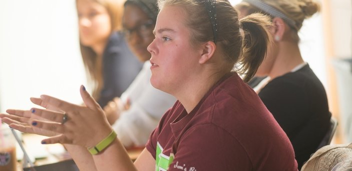 Student in classroom asking a question