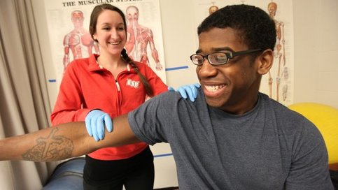 Athletic training student with patient