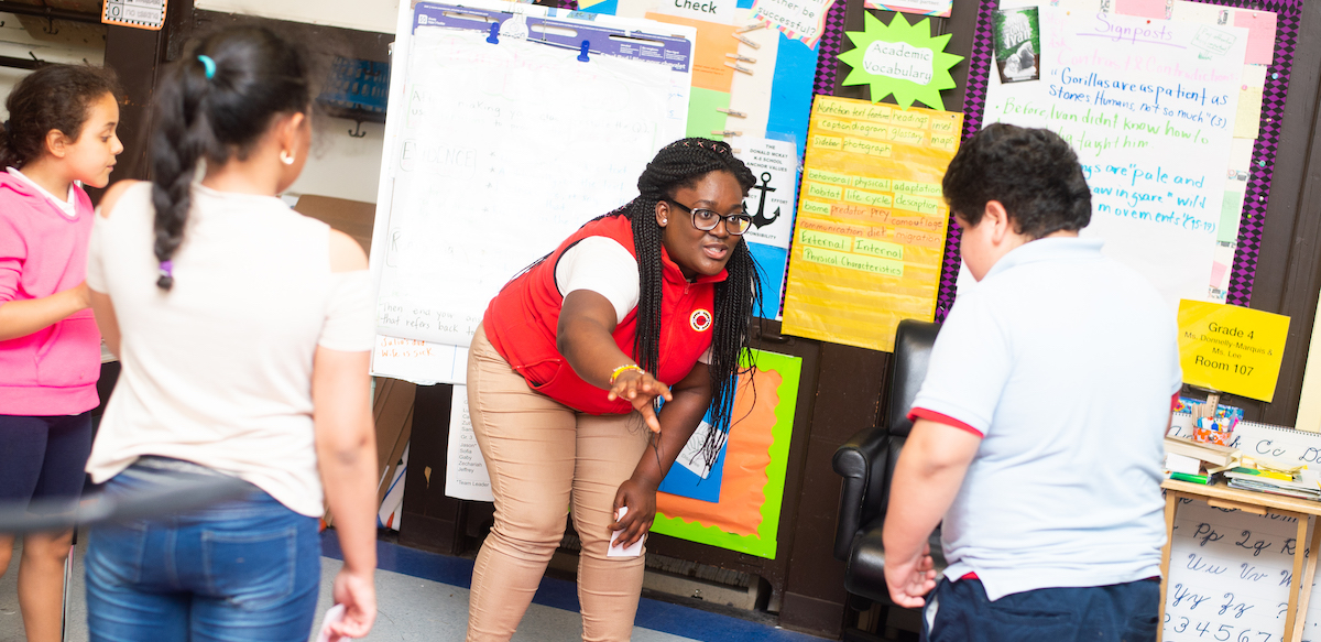 City Year volunteer working with children