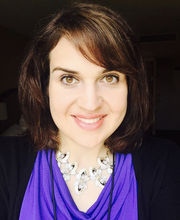 headshot photo of Lisa Litterio with medium length brown hair, a purple blouse and black jacket