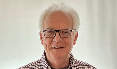 Headshot of Joe Burns in front of a white background.