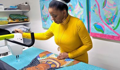  A woman stands working in an art studio 