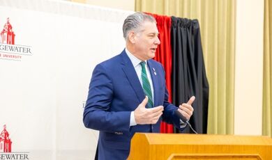 Peter Koutoujian speaks from a podium.