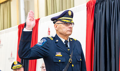 The new chief raises his right hand to be sworn in.