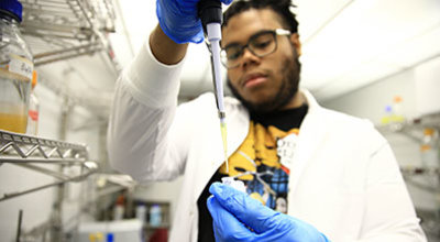 Biochemistry student Fergens Lyncee working in the lab