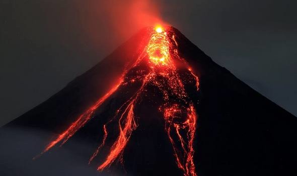 an active volcano with hot lava flowing down it and red gases emanating off the top
