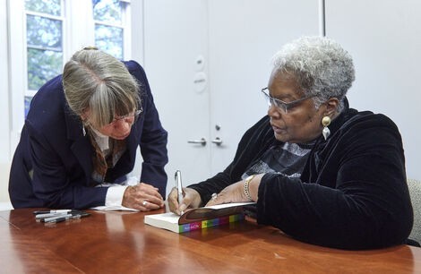 Dr. Ann DuCille, right, signs a book at a recent event