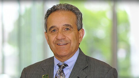 Headshot of Robert Antonucci standing in front of a corridor of windows.