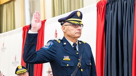 The new chief raises his right hand to be sworn in.