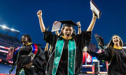 Graduate students celebrate after receiving degrees