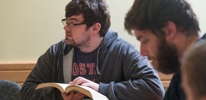 A student participating in class discussion