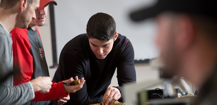 Students choosing rocks in geology class