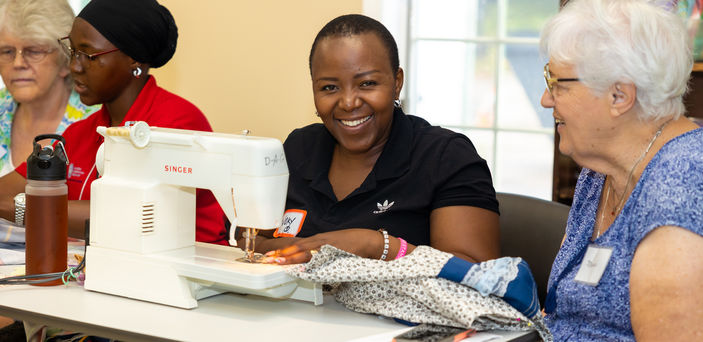 A Mandela fellow sews a dress.